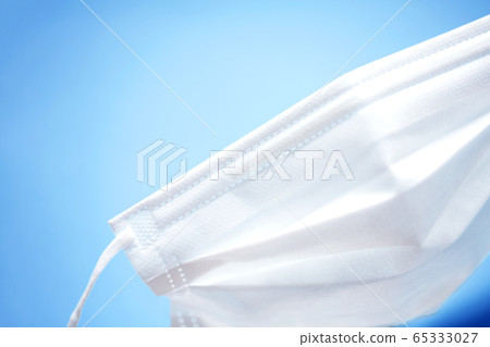 White mask on the right and blue back and copy space on the left White mask on the right and blue back and copy space on the left 65333027