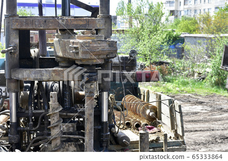 Construction machine for drilling holes in the 65333864