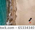 Areal top down view on sand beach and lifeguard tower on the island of Mallorca Mediterranean sea Port Adriano. Port Adriano, El Toro, Palma De Mallorca, Spain. Soft wave of blue ocean on sandy beach. 65334340