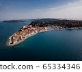 Aerial view on Piran town with old lighthouse, ancient buildings with red roofs, the port of Piran with boats and Adriatic sea in southwestern Slovenia 65334346