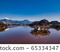 Famous lake red color and island Bled (Blejsko jezero) in Slovenia. Beautiful alpine mountain lake with Pilgrimage Church of the Assumption of Maria and Bled Castle and small town in background. 65334347