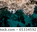 Areal top down view Island scenery, seascape Spain Majorca, beach bay Cala s'Almunia, beautiful coastline Mediterranean Sea. Balearic Islands, Cliff of Cala S'Almunia in Santanyi 65334592
