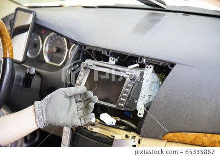 A person who repairs the audio system of a passenger car. A person who repairs the audio system of a passenger car. 65335867