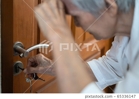 Tired elderly with hand on her forehead,trying to open the door,unlocking,having trouble seeing key,vision problems, blurred vision,opening the locked door,asian senior woman with eyesight problem Tired elderly with hand on her forehead,trying to open the door,unlocking,having trouble seeing key,vision problems, blurred vision,opening the locked door,asian senior woman with eyesight problem 65336147