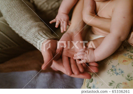 human hands of mom and baby dad 65336261