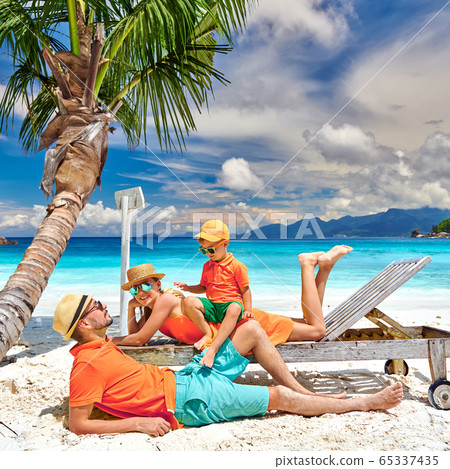 Family with three year old boy on beach. Family with three year old boy on beach. 65337435
