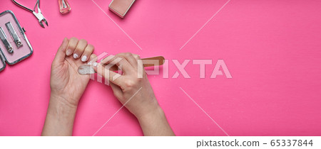 Overgrown nails with an old cracked gel polish. Self-removal of old gel polish from nails with a nail file. Overgrown nails with an old cracked gel polish. Self-removal of old gel polish from nails with a nail file. 65337844