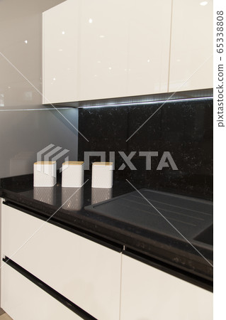 Interior of luxurious modern kitchen white grey Interior of luxurious modern kitchen white grey 65338808