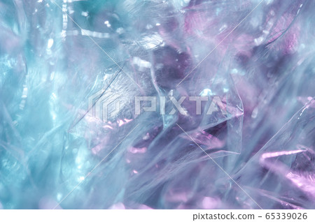 Holographic background in the style of the 80-90s. Real texture of cellophane film in bright acid colors. Holographic background in the style of the 80-90s. Real texture of cellophane film in bright acid colors. 65339026