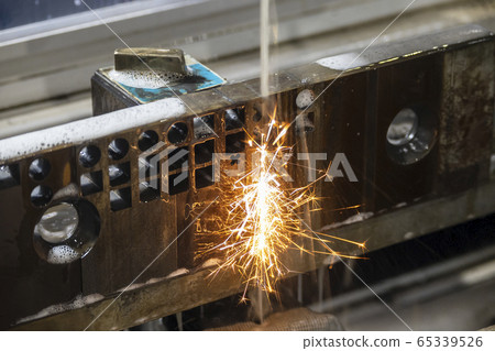 The wire-EDM machine cutting the die parts. The wire-EDM machine cutting the die parts. 65339526