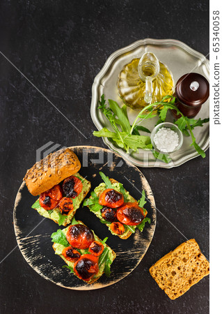 Vertical shot of a plate with delicious vegan avocado sandwiches Vertical shot of a plate with delicious vegan avocado sandwiches 65340058