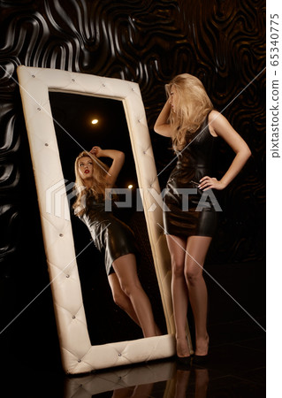 Prett young girl in short black dress Prett young girl in short black dress 65340775
