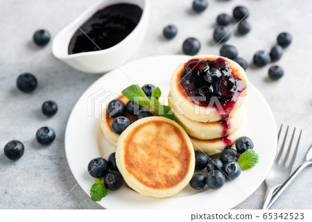 Syrniki or cottage cheese fritters with jam Syrniki or cottage cheese fritters with jam 65342523