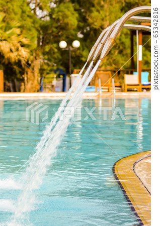 Clean water flowing from many swan necks in a pool Clean water flowing from many swan necks in a pool 65342816