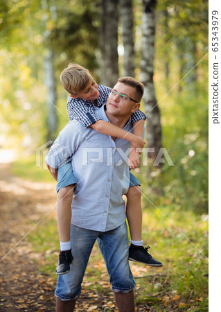 A Father and son in forest on a meadow 65343979