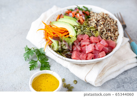 Healthy raw tuna bowl with quinoa and vegetales. Buddha bowl 65344060