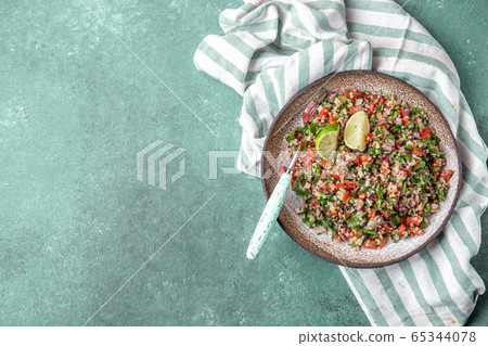 Traditional Lebanese salad tabouli tabule with quinoa, herbs, tomatoes, mint and lemon Traditional Lebanese salad tabouli tabule with quinoa, herbs, tomatoes, mint and lemon 65344078