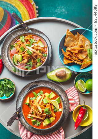 Mexican style table with spicy aztec soup with tortilla. Copy space 65344098