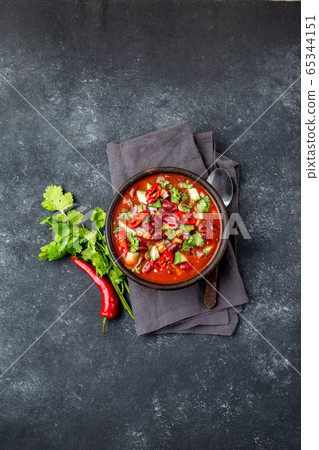 Mexican black bean tomato soup in clay bowl. Gray background Mexican black bean tomato soup in clay bowl. Gray background 65344151