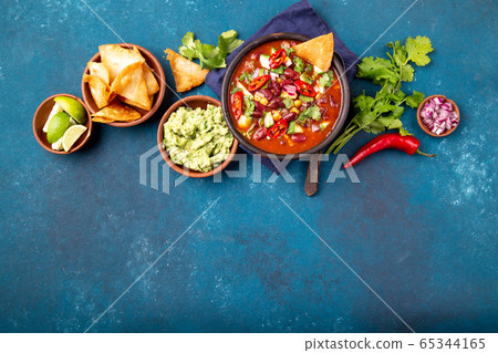 Mexican food concept background with chile black bean soup, guacamole and nachos totopos. Top view 65344165