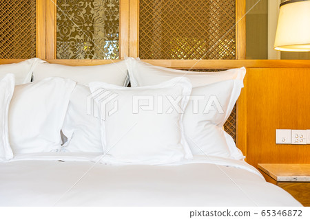 Comfortable white pillow on bed decoration in bedroom Comfortable white pillow on bed decoration in bedroom 65346872