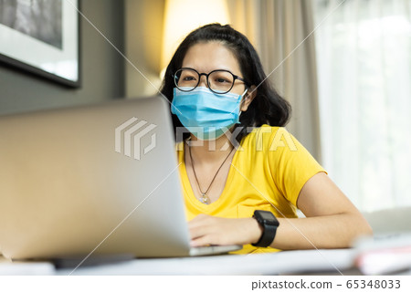 Asian female wear eyeglasses using laptop computer Asian female wear eyeglasses using laptop computer 65348033