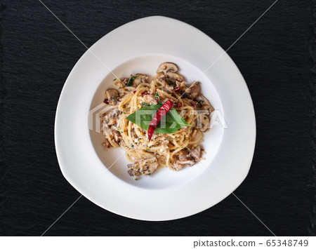 Stir fry Spaghetti with salted fish, Thai spices and dry chili 65348749