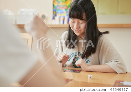 Family playing board games 65349517