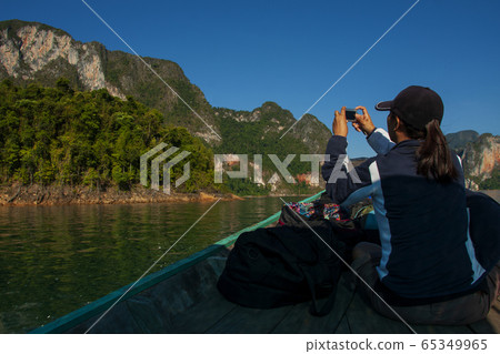 Beautiful mountains and river natural attractions from long tail boat in Ratchaprapha Dam at Khao Sok National Park, Surat Thani Province, Thailand 65349965