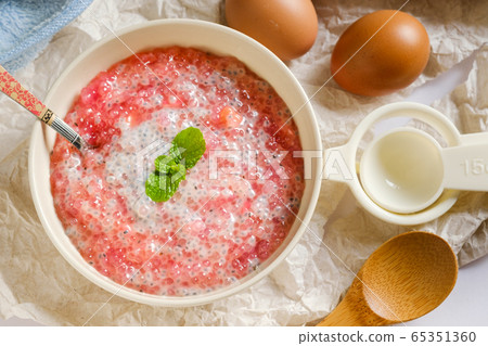 A bowl of sweet red sago in coconut cream.Asian A bowl of sweet red sago in coconut cream.Asian 65351360