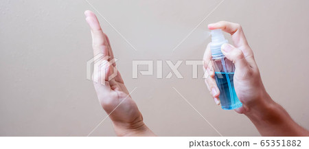 Man spraying alcohol sanitizer bottle to hand, Man spraying alcohol sanitizer bottle to hand, 65351882