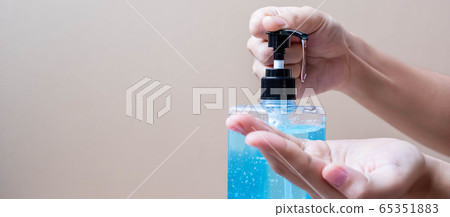 Man hands using wash hand alcohol gel or sanitizer Man hands using wash hand alcohol gel or sanitizer 65351883