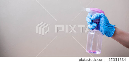 Man spraying disinfectant bottle, prevent Man spraying disinfectant bottle, prevent 65351884