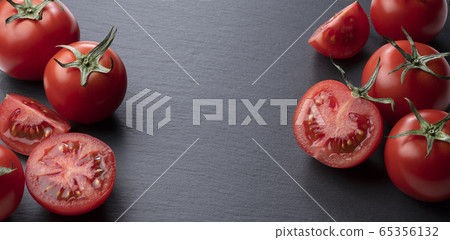 Tomatoes placed on black stone background 65356132