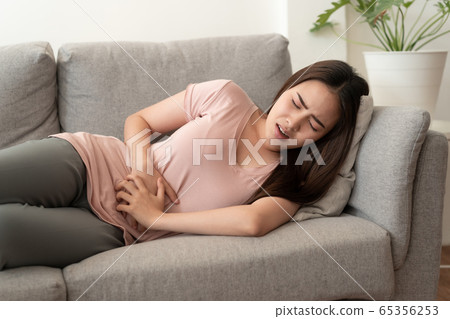 Asian women with menstrual pain at abdomen And the face expression 65356253