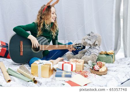 Woman playing Christmas song Woman playing Christmas song 65357748