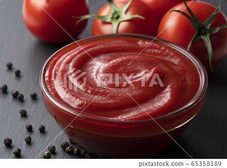 Black stone background with ketchup, tomato and black pepper 65358189