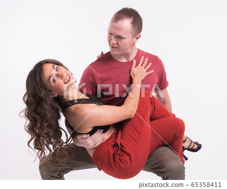 Beauty couple dancing social dance. Kizomba or bachata or semba or taraxia , on white background. Social dance concept. Beauty couple dancing social dance. Kizomba or bachata or semba or taraxia , on white background. Social dance concept. 65358411