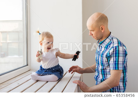 Father with his cheerful baby girl daughter. Single parent. Fatherhood, father's day and family concept. 65358456