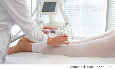 woman uses a professional device during a vacuum massage procedure 65359272