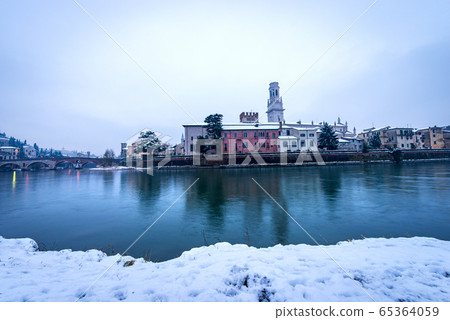 River Adige and Verona cityscape in winter with snow - Veneto Italy 65364059