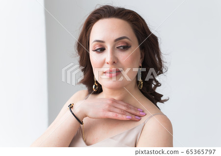 Close-up of beautiful woman wearing bracelet. Accessories, jewelry and bijouterie concept. 65365797