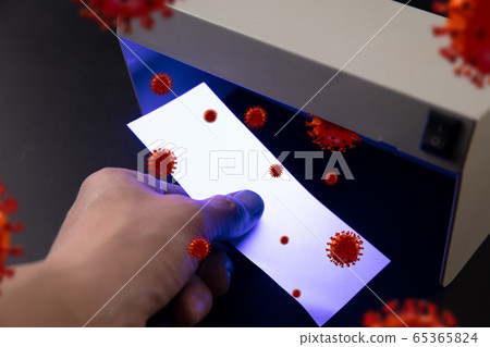 Male hands checking of banknotes in the detector, 3D models of coronavirus spreding around Male hands checking of banknotes in the detector, 3D models of coronavirus spreding around 65365824