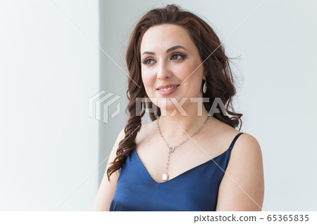 Close-up portrait of beautiful young woman with elegant hairstyle and luxurious jewelry and bijouterie. Close-up portrait of beautiful young woman with elegant hairstyle and luxurious jewelry and bijouterie. 65365835