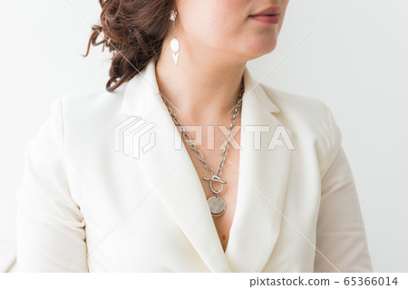 Close-up of woman wearing a Jewelry, bijouterie and accessories. Close-up of woman wearing a Jewelry, bijouterie and accessories. 65366014