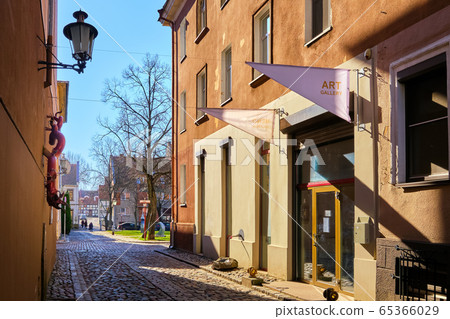 Cobbled pavements of old town streets in Klaipeda, Lithuania on sunny day. Old buildings, houses, galleries, shops, restaurants 65366029