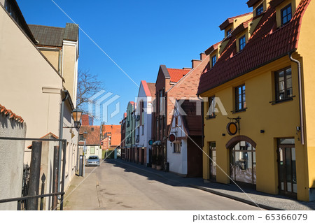 Cobbled pavements of old town streets in Klaipeda, Lithuania on sunny day. Old buildings, houses, galleries, shops, restaurants 65366079