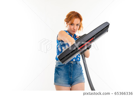 housewife cleans the room with a vacuum cleaner on a white background housewife cleans the room with a vacuum cleaner on a white background 65366336