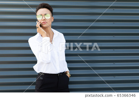 Female in office suit made an appointment and call the phone outside Female in office suit made an appointment and call the phone outside 65366346