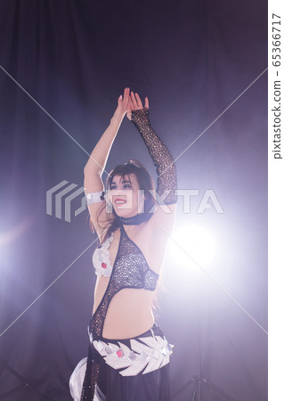 Spirituality dance. Beautiful sexy woman with luxury glossy eastern make-up dancing tribal fusion. Belly dance. Spirituality dance. Beautiful sexy woman with luxury glossy eastern make-up dancing tribal fusion. Belly dance. 65366717